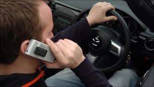 image of man driving using phone