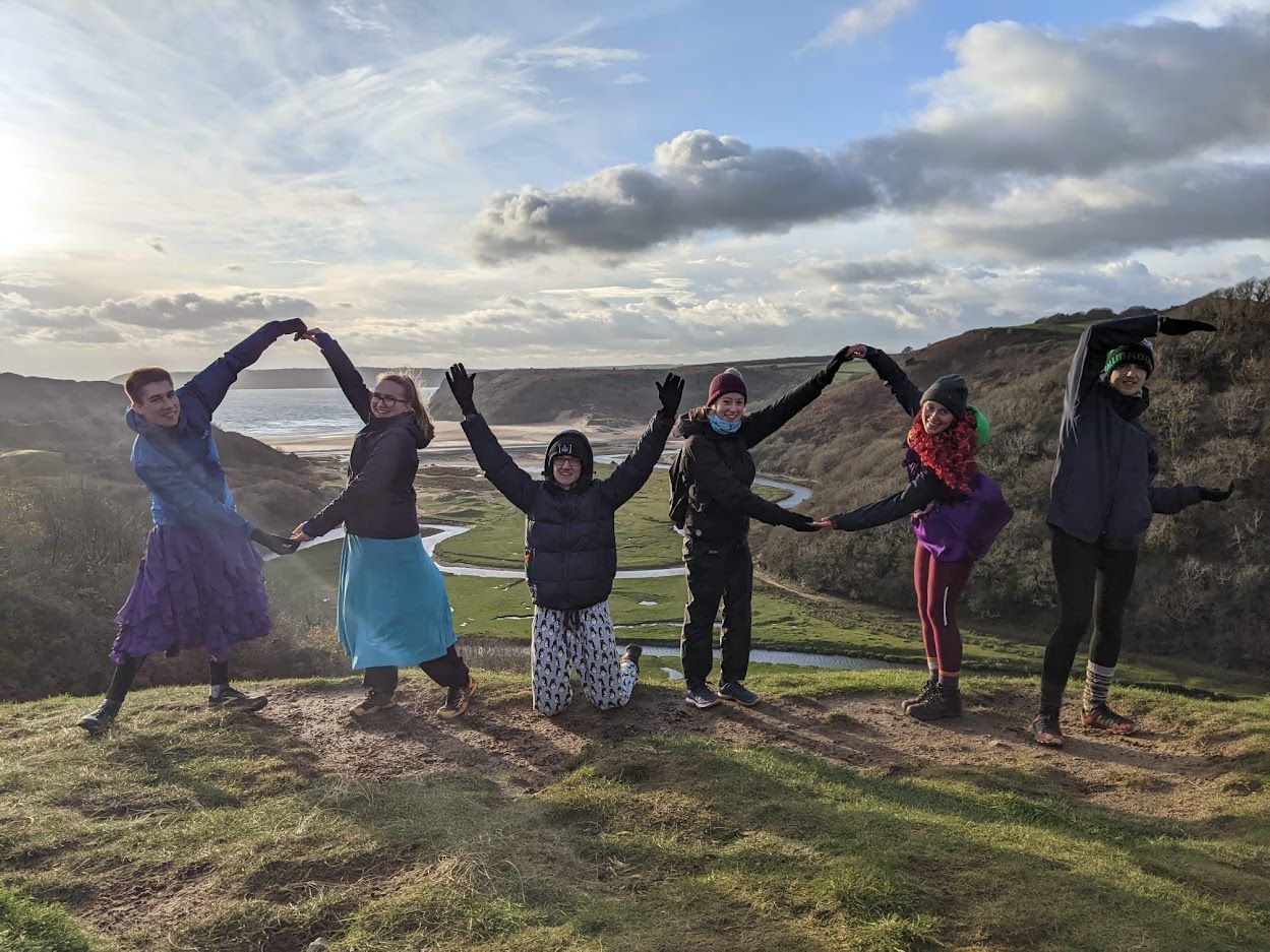 OUOC making letters with their arms