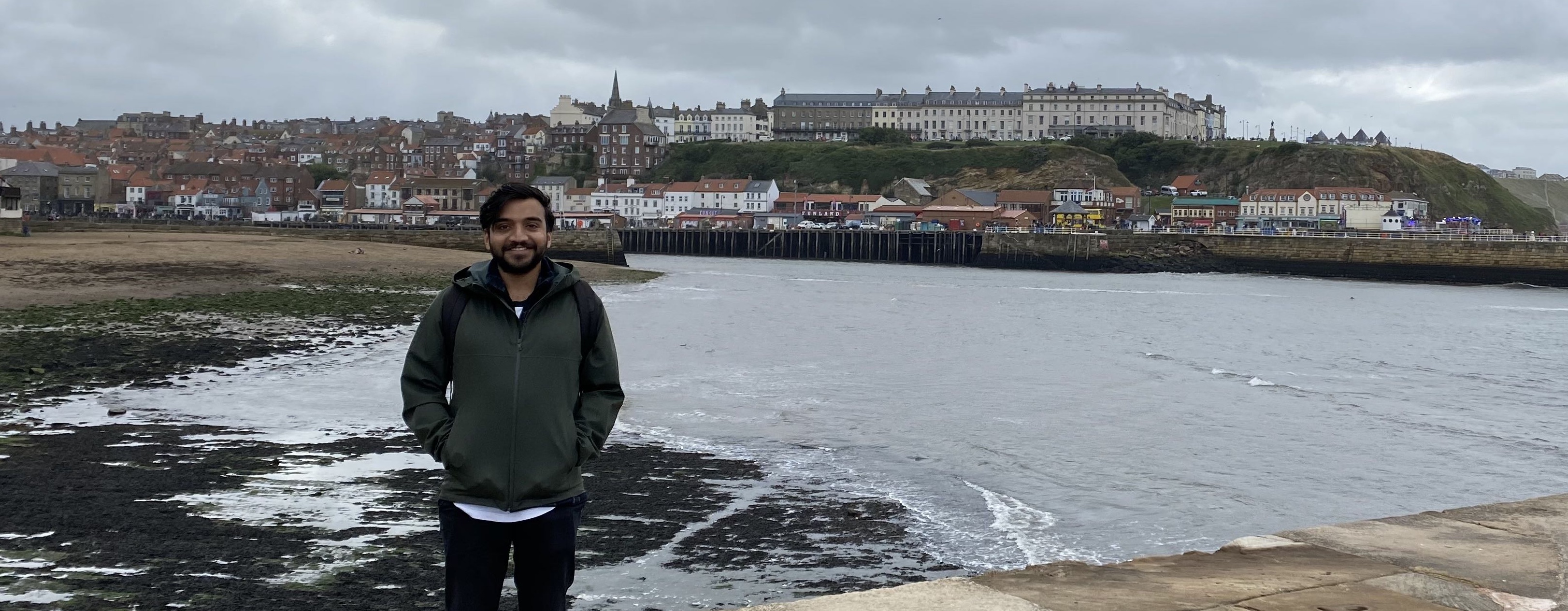 Aayush Saxena standing in front of a coast line