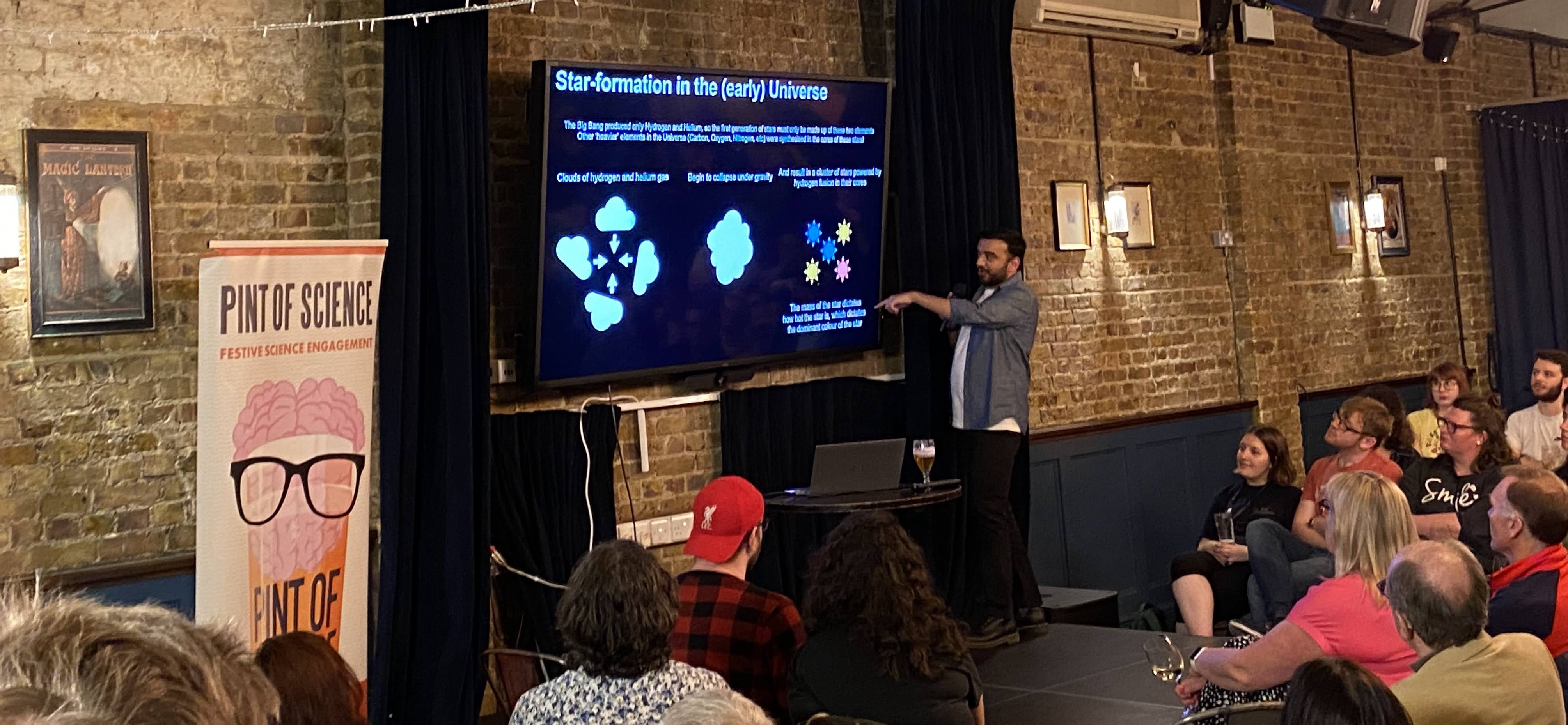 Aayush Saxena giving a talk at the Pint of Science festival in London
