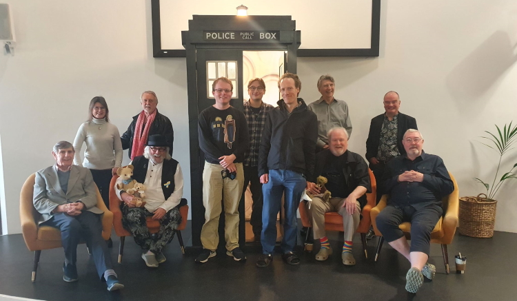 James, Adam, and Ian with Peter Roy, Sophie Alred, Roger Murray-Leach, Terry Molloy, David Banks, Colin Baker, Mike Tucker, and Brian Croucher at Bedford Who Charity Convention 7 in 2022